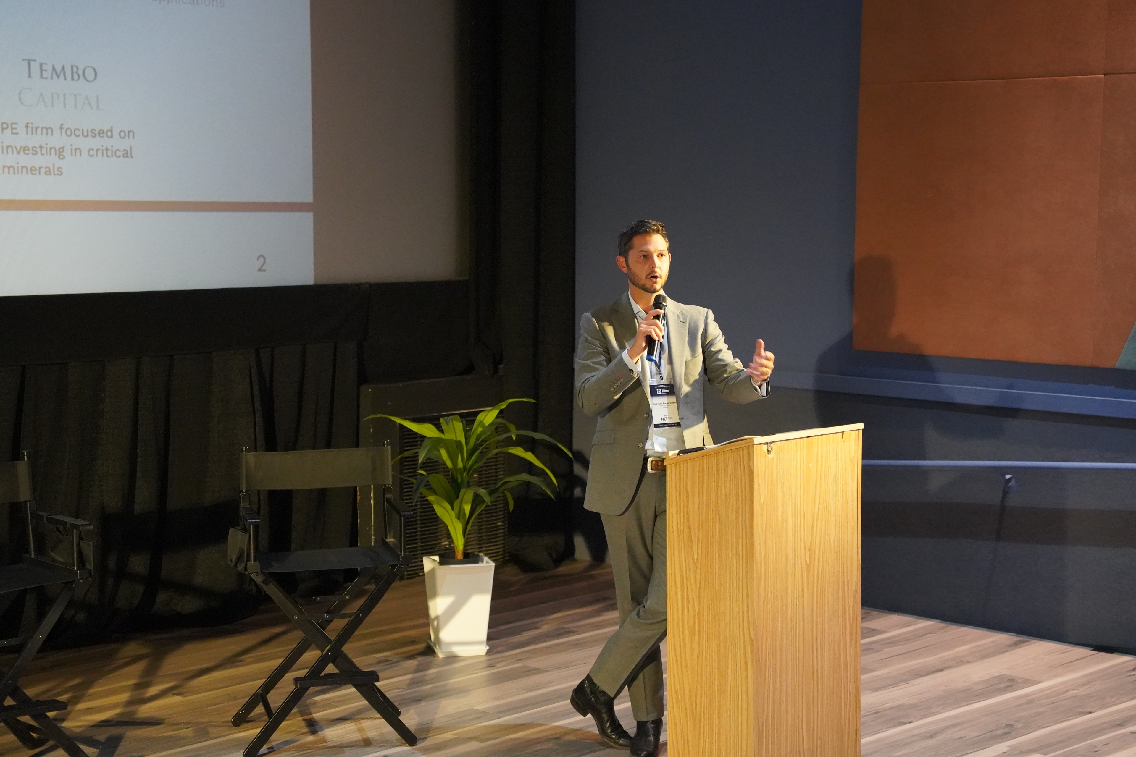 Suited speaker presenting in the auditorium