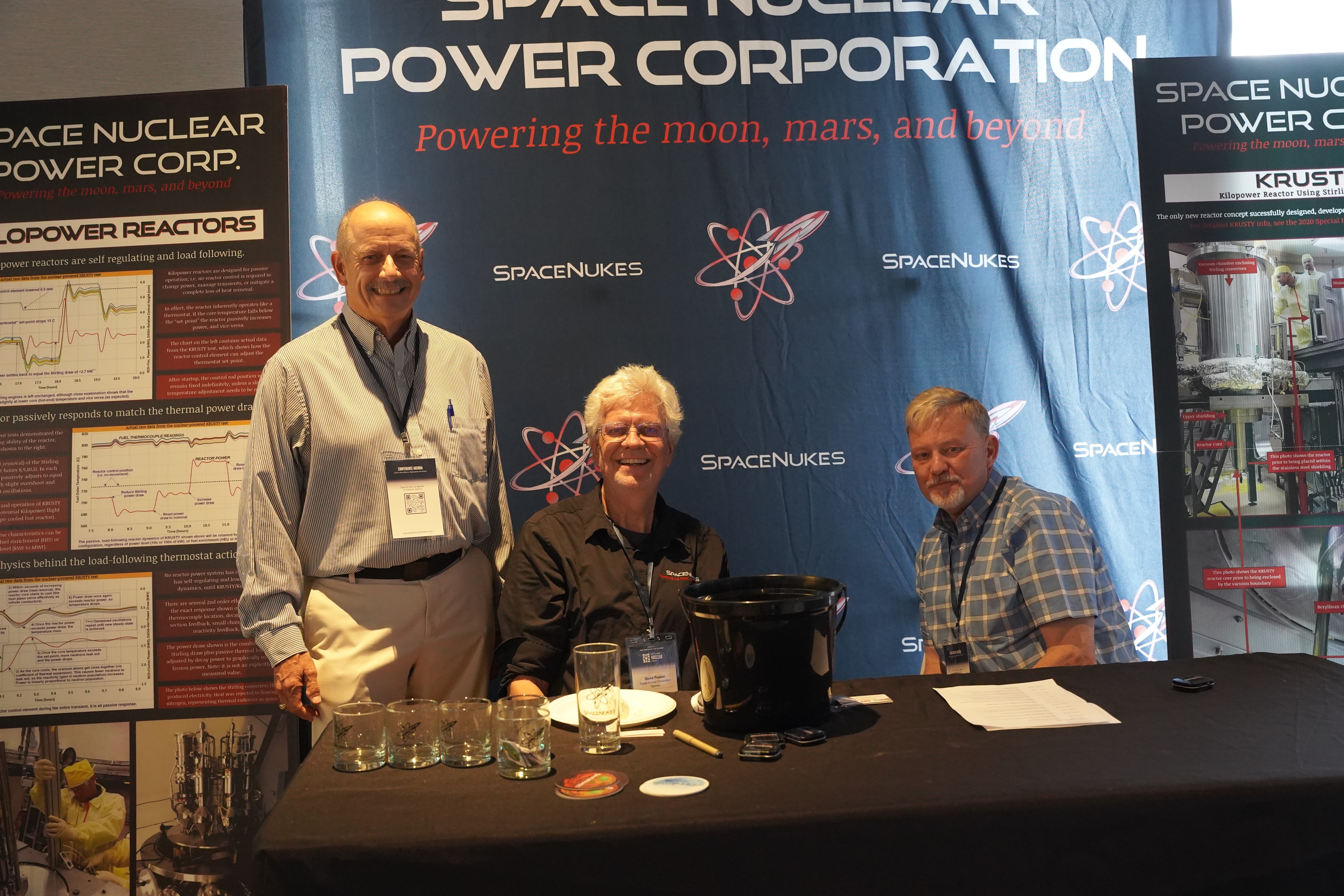 Attendees at the SpaceNukes Power Corporation exhibition booth